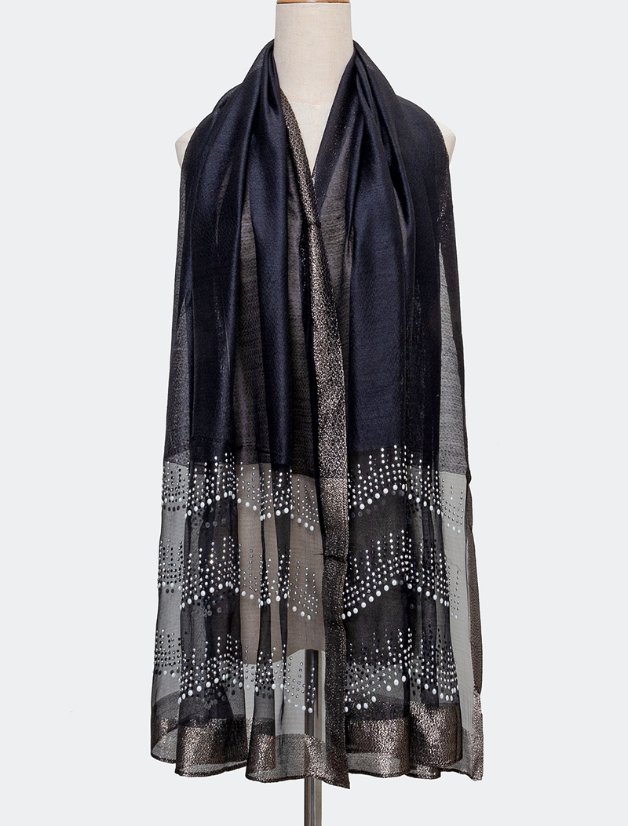 Dark decorated scarf hanging on a plain display form to show both long ends